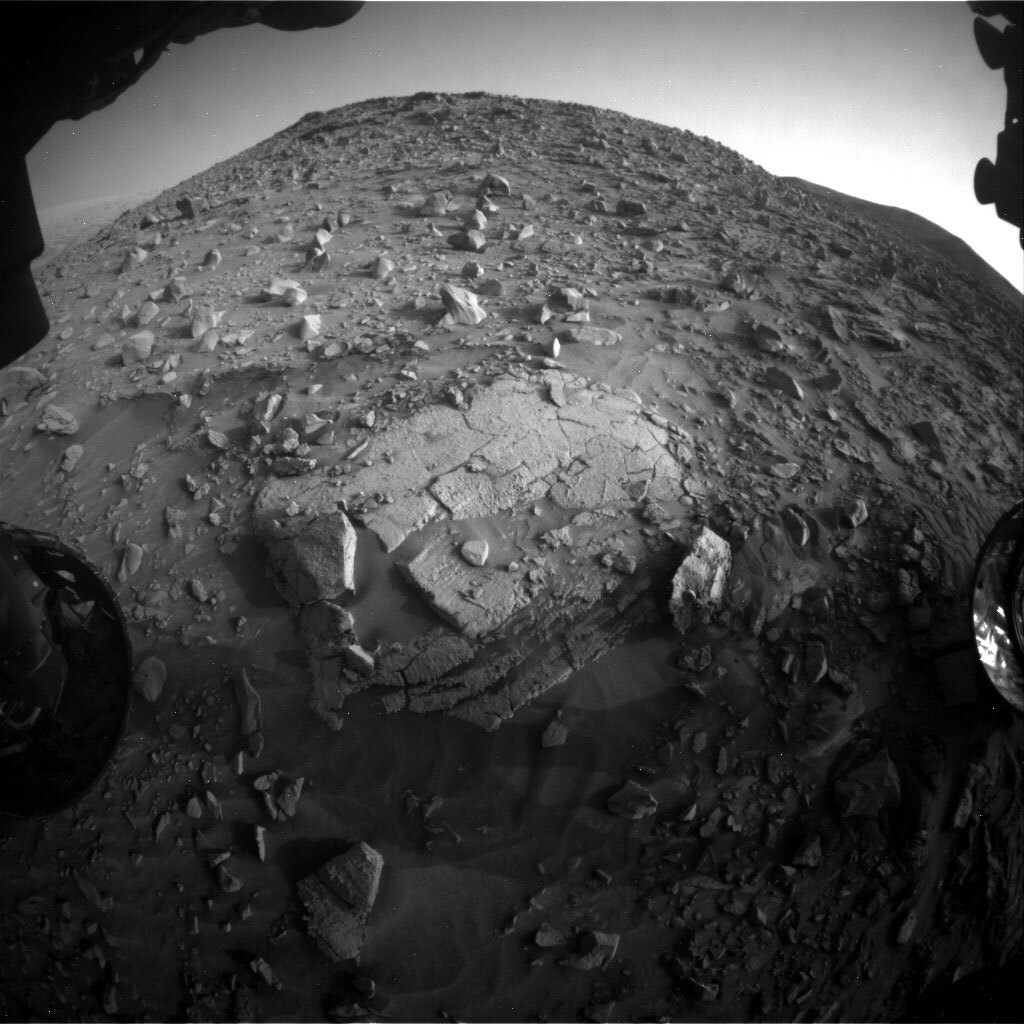 Curiosity’s workspace had a big piece of bedrock in plain view! This image was taken by Front Hazard Avoidance Camera (Front Hazcam) onboard NASA's Mars rover Curiosity on Sol 3449. Credits: NASA/JPL-Caltech.