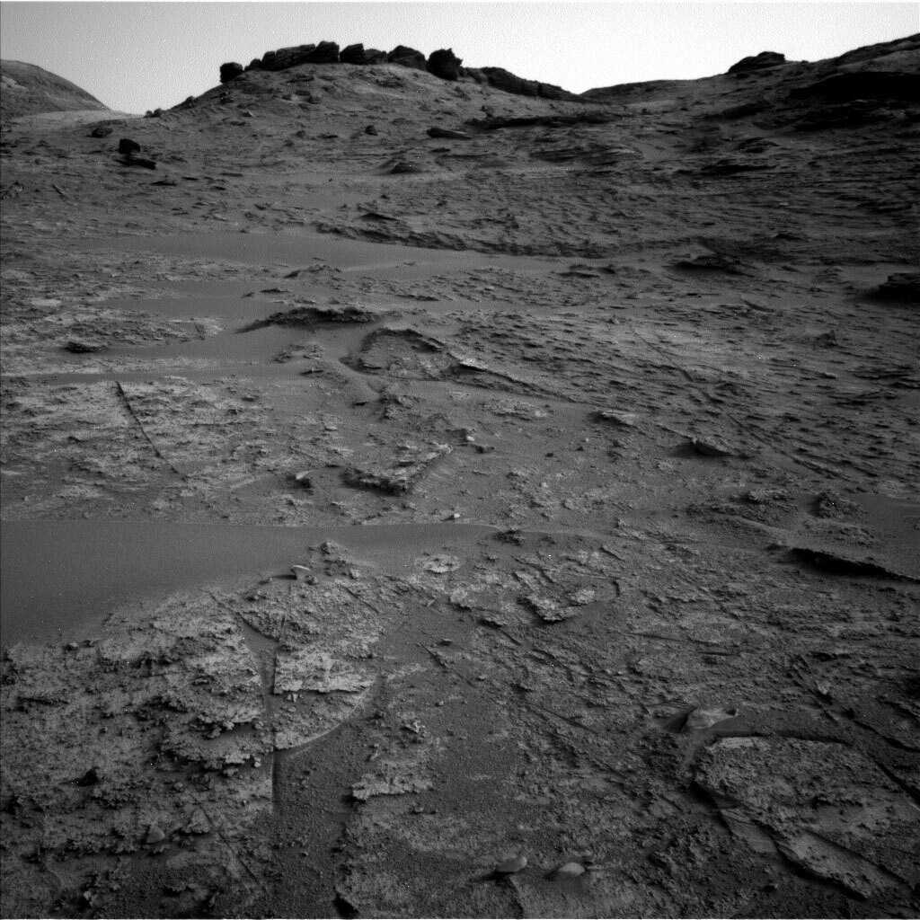 This is an image of the Martian surface with rocky hills in the background.