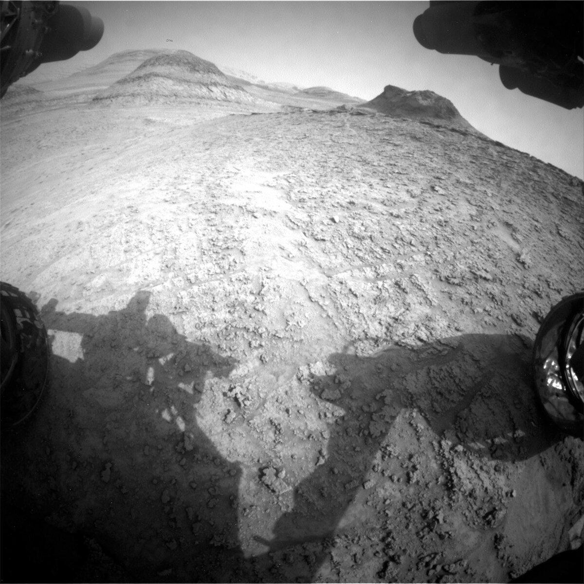 This front hazcam image taken by Curiosity shows the thin, resistant Marker band outcrop in top right of the image and the buttes ahead to the south on Mars on sol 3700.