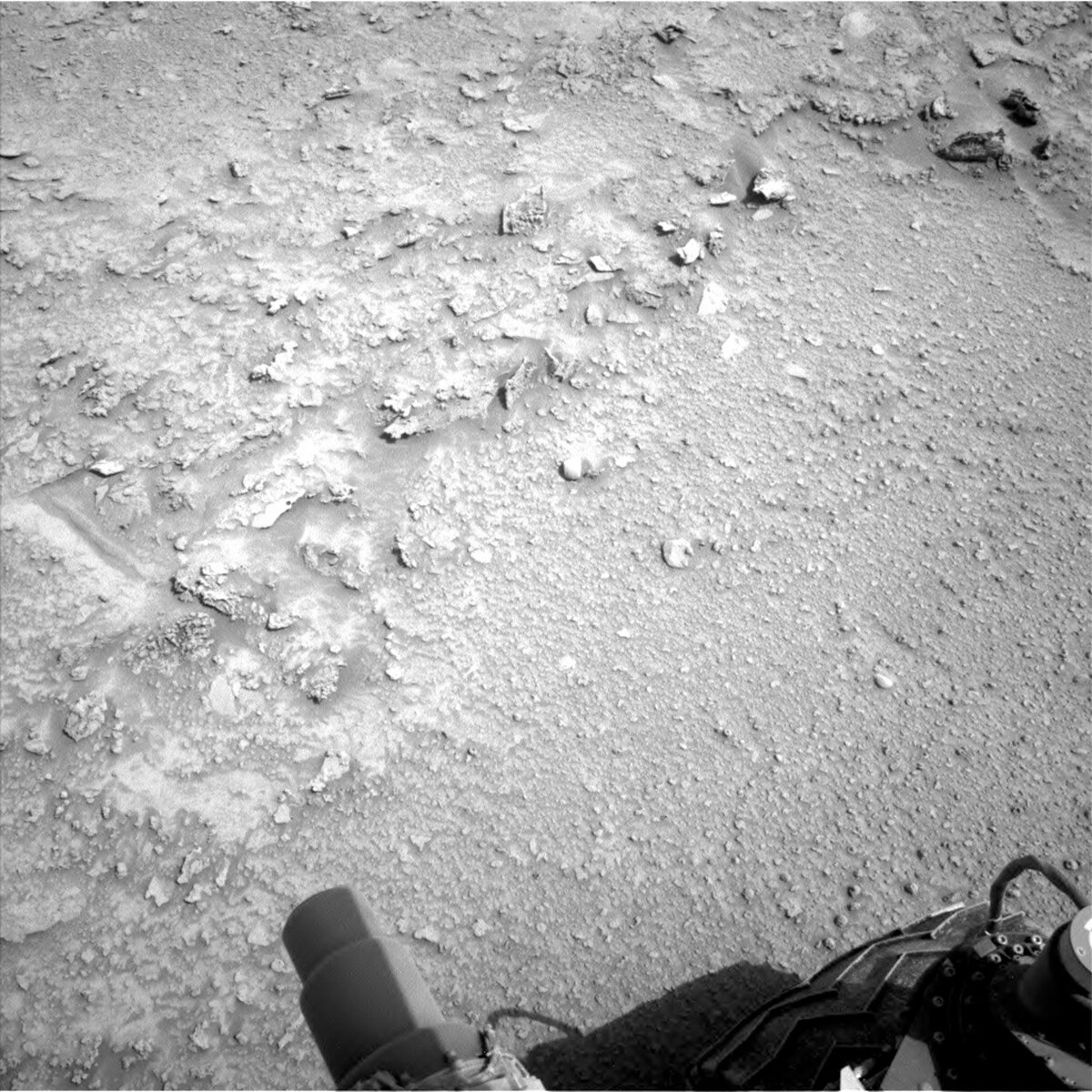 This image of Martian rocky terrain with part of the Curiosity rover in the right lower corner was taken by Left Navigation Camera onboard NASA's Mars rover Curiosity on Sol 3727.