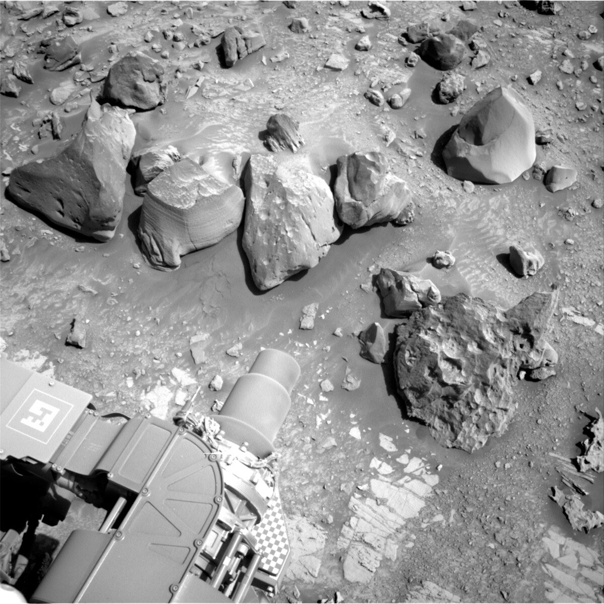Image shows right Navcam image of MSL's sol 3924 Mars workspace including boulder targets Mytikas, Helmos, and Epidaurus.