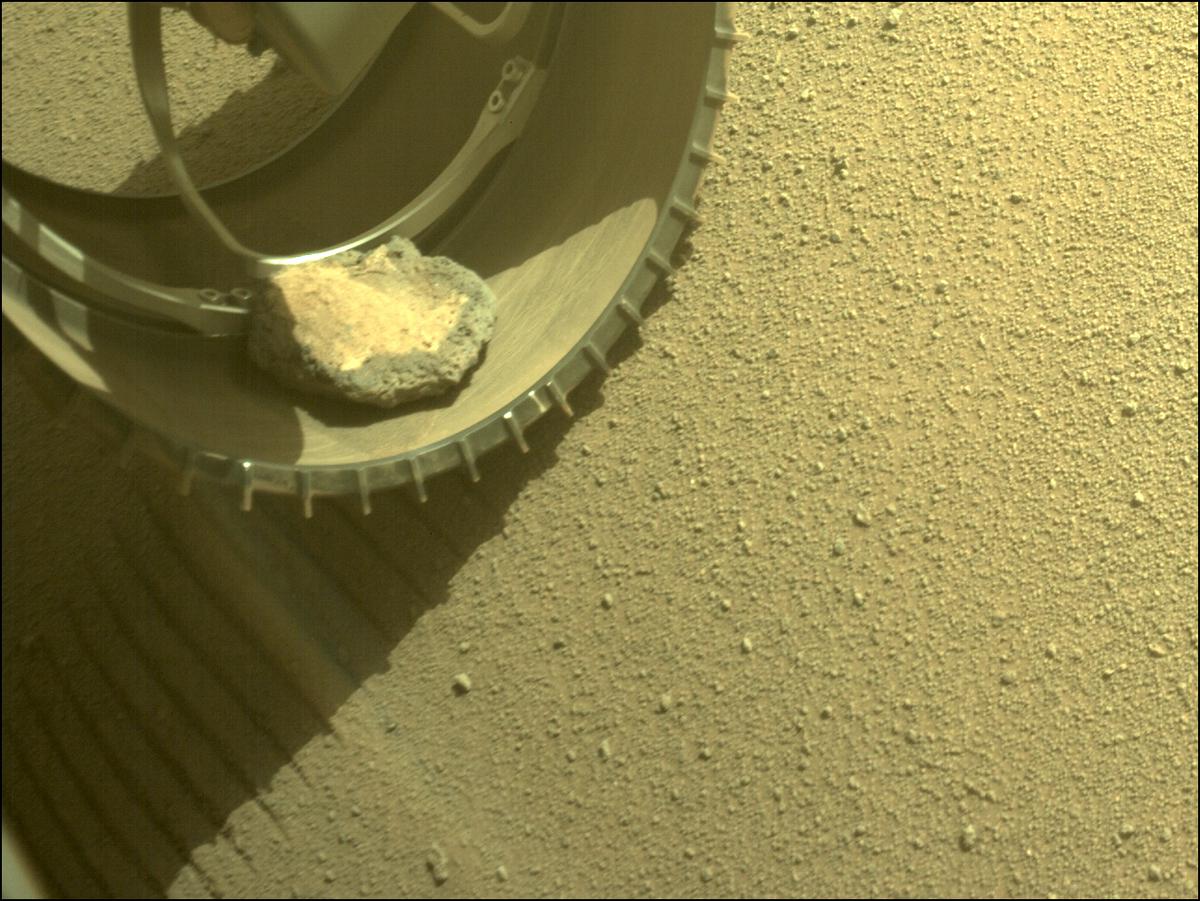 A rock in the front left wheel of Perseverance on Sol 343, image was acquired on Feb. 6, 2022 (Sol 343).