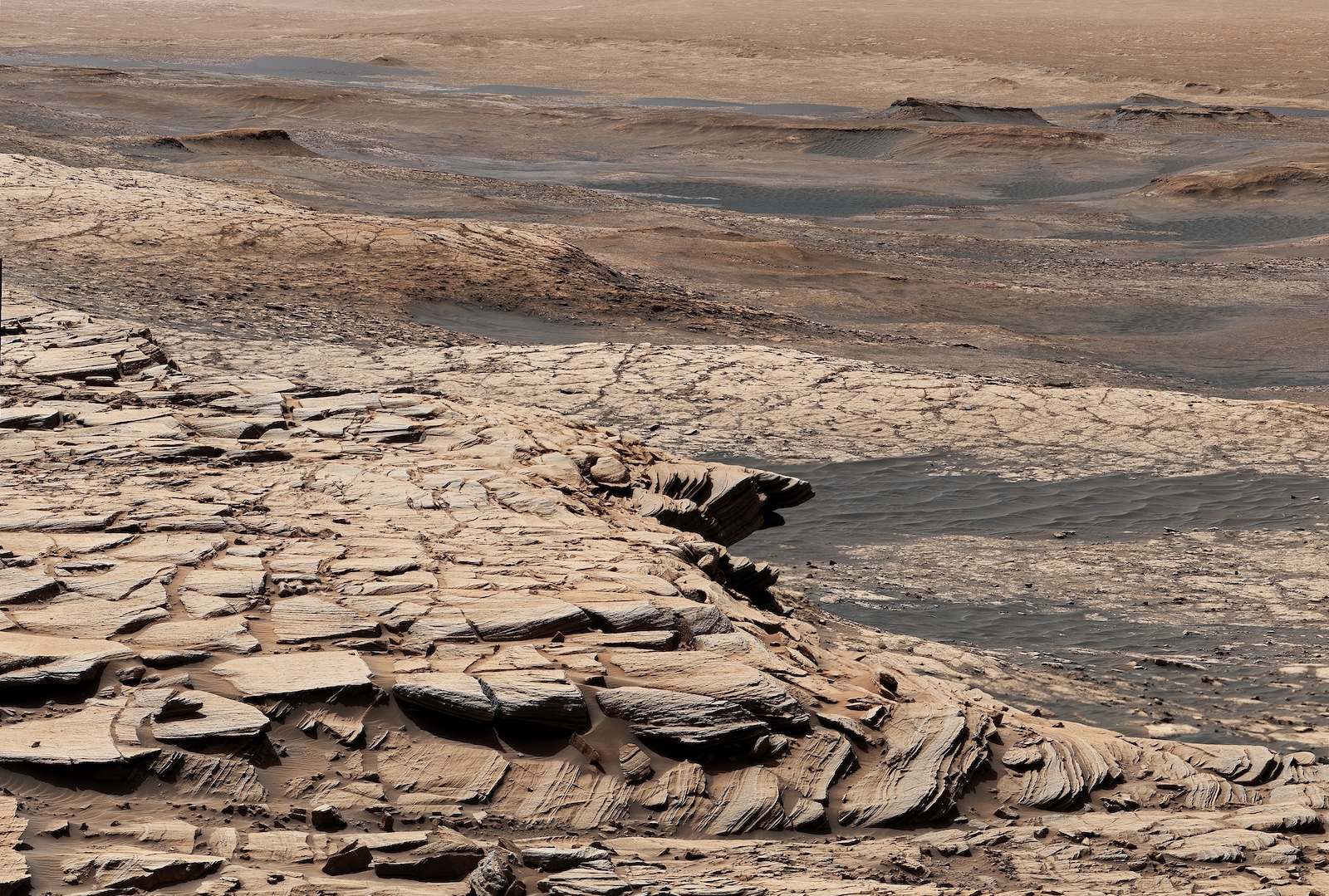 NASA's Curiosity Mars rover captured a partial image of a geologic feature called "Greenheugh Pediment." In the foreground is the crusty sandstone cap that stretches the length of the pediment, forming an overhanging ledge in some parts.