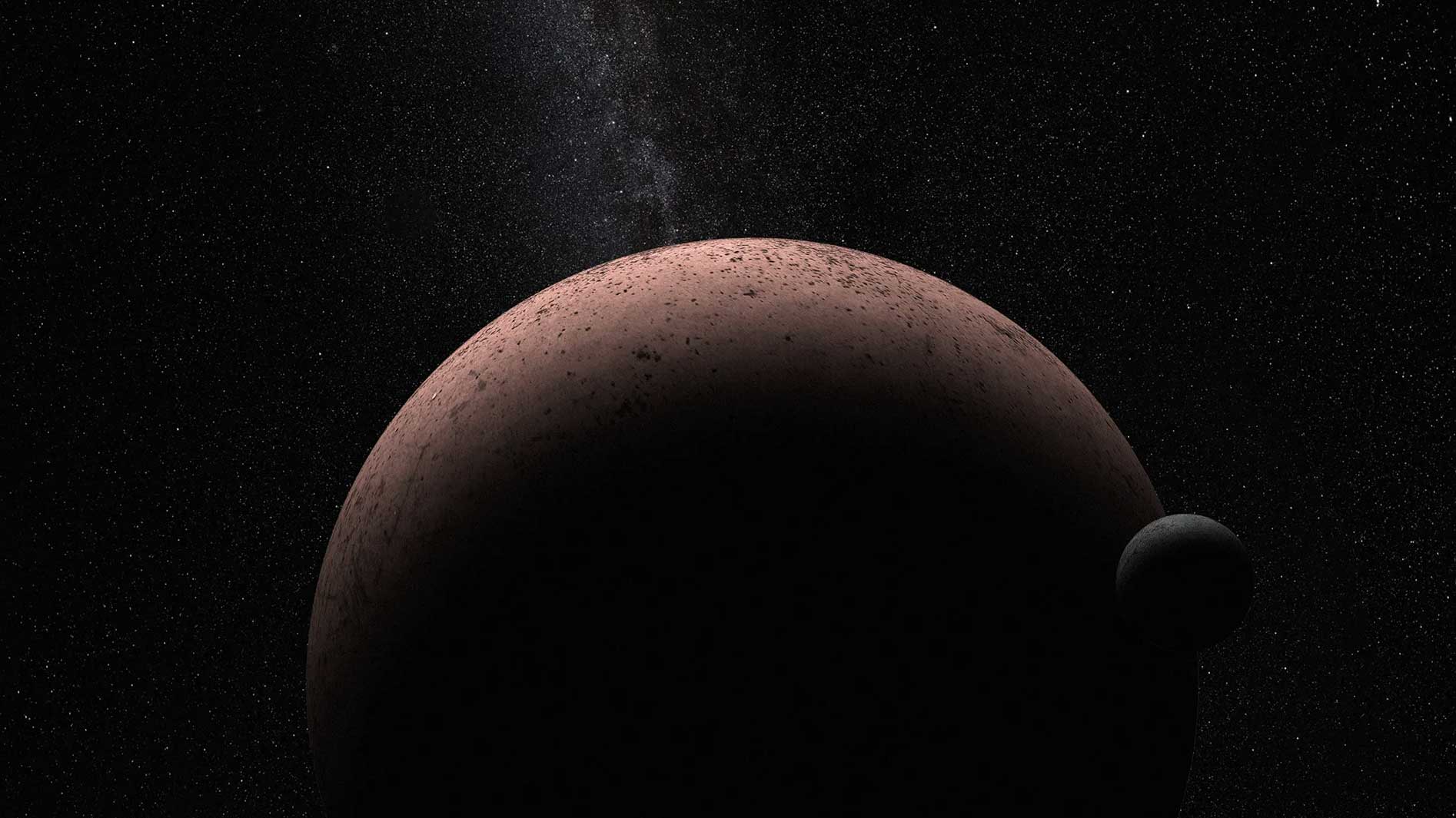 The top of red dwarf planet Makemake with its moon to the right and in front.