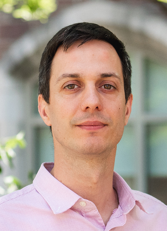 Manel Errando headshot, male, black hair, pink collared shirt.