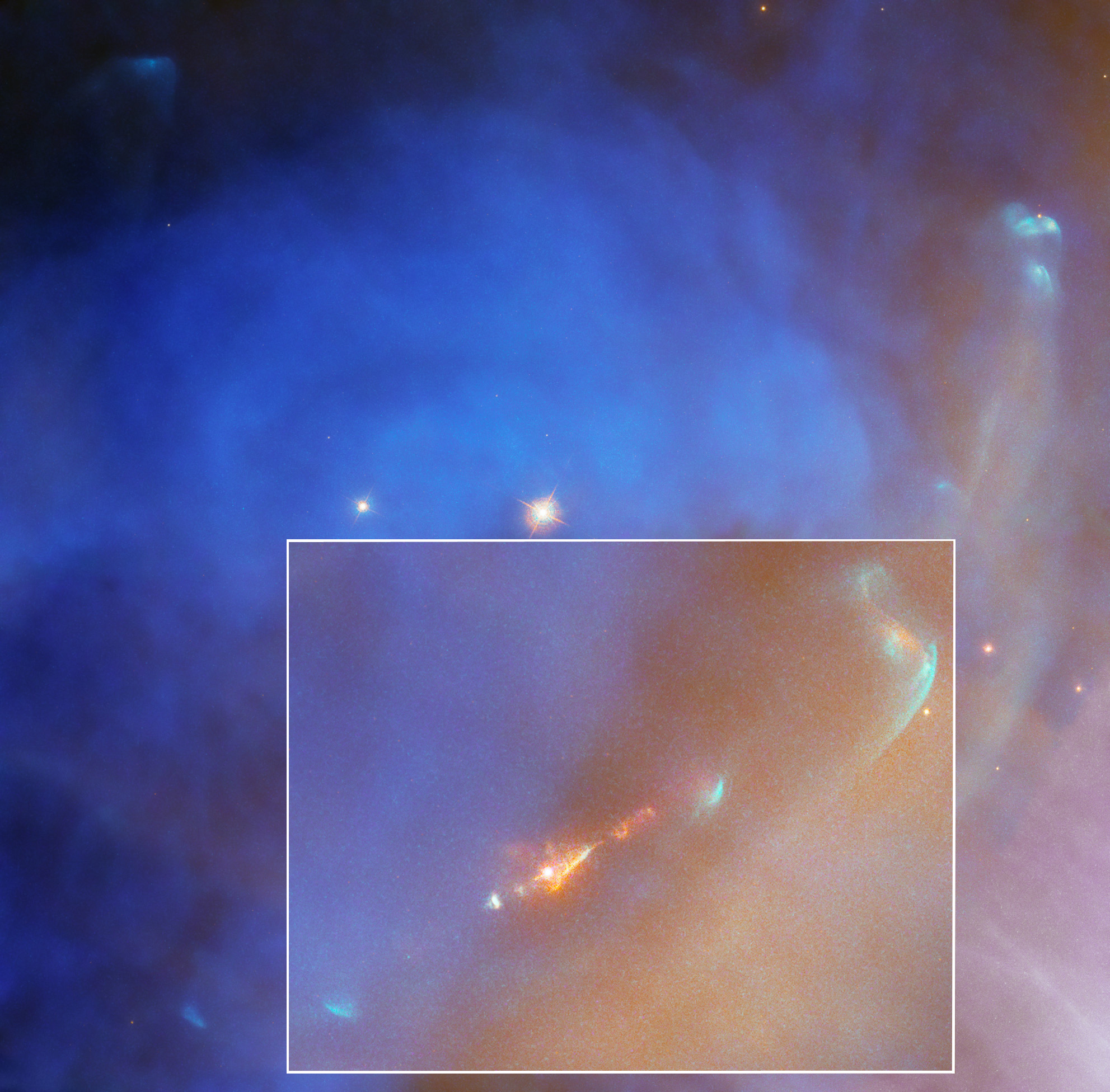 Hubble image of NGC 1977. Bright blue cloud with a reddish-orange jet (bottom, center). Far-right side and bottom right corner, reddish-orange cloud