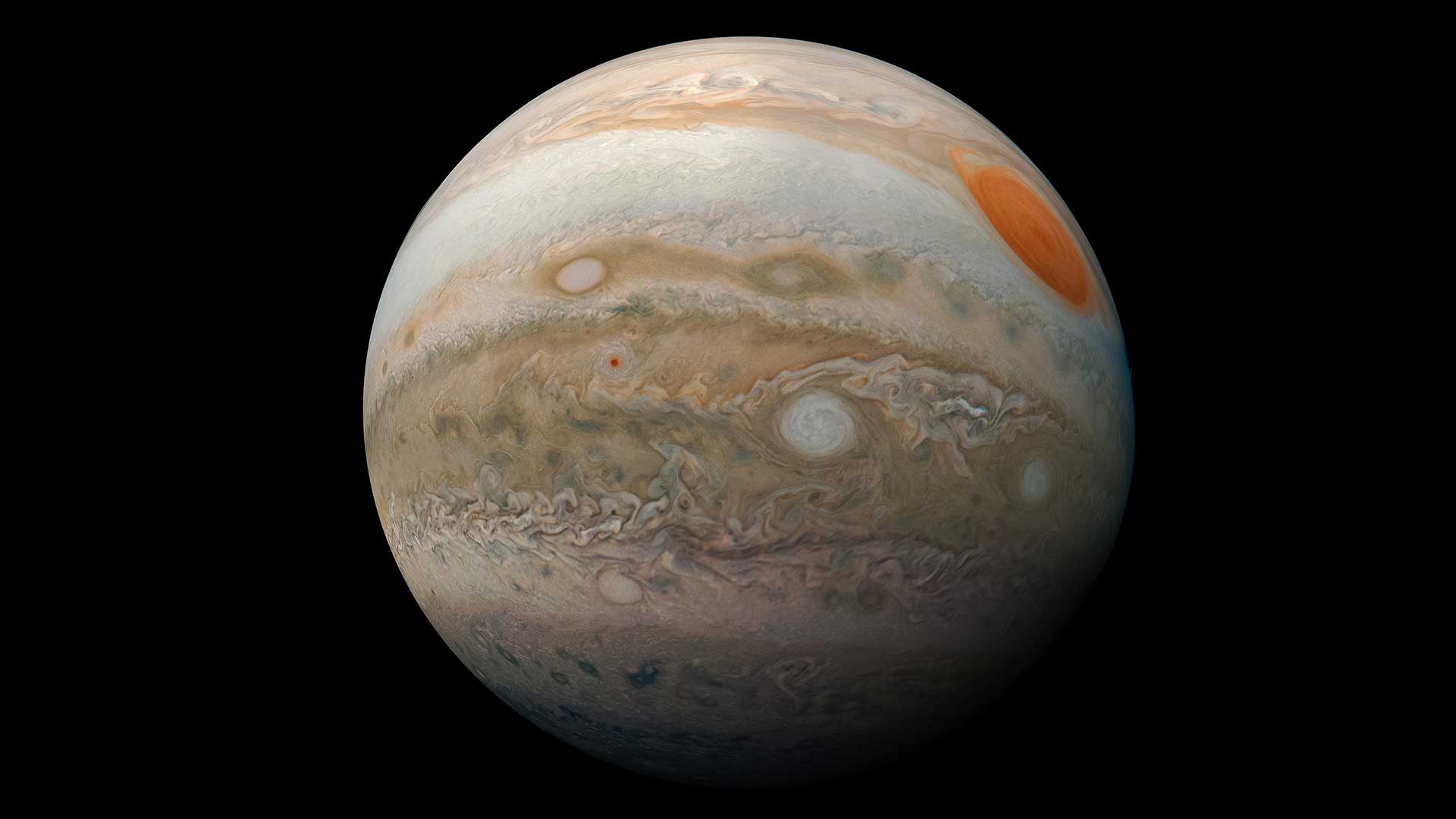 A view of Jupiter's Great Red Spot and colorful cloud bands of tan, brown, white, and orange as seen from the Juno spacecraft.