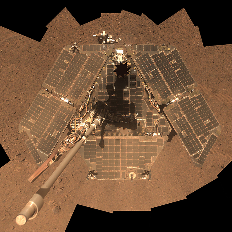 This composite view shows the rover and its dusty solar panels from above.