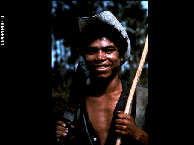 Portrait of a smiling man holding tools over his shoulders