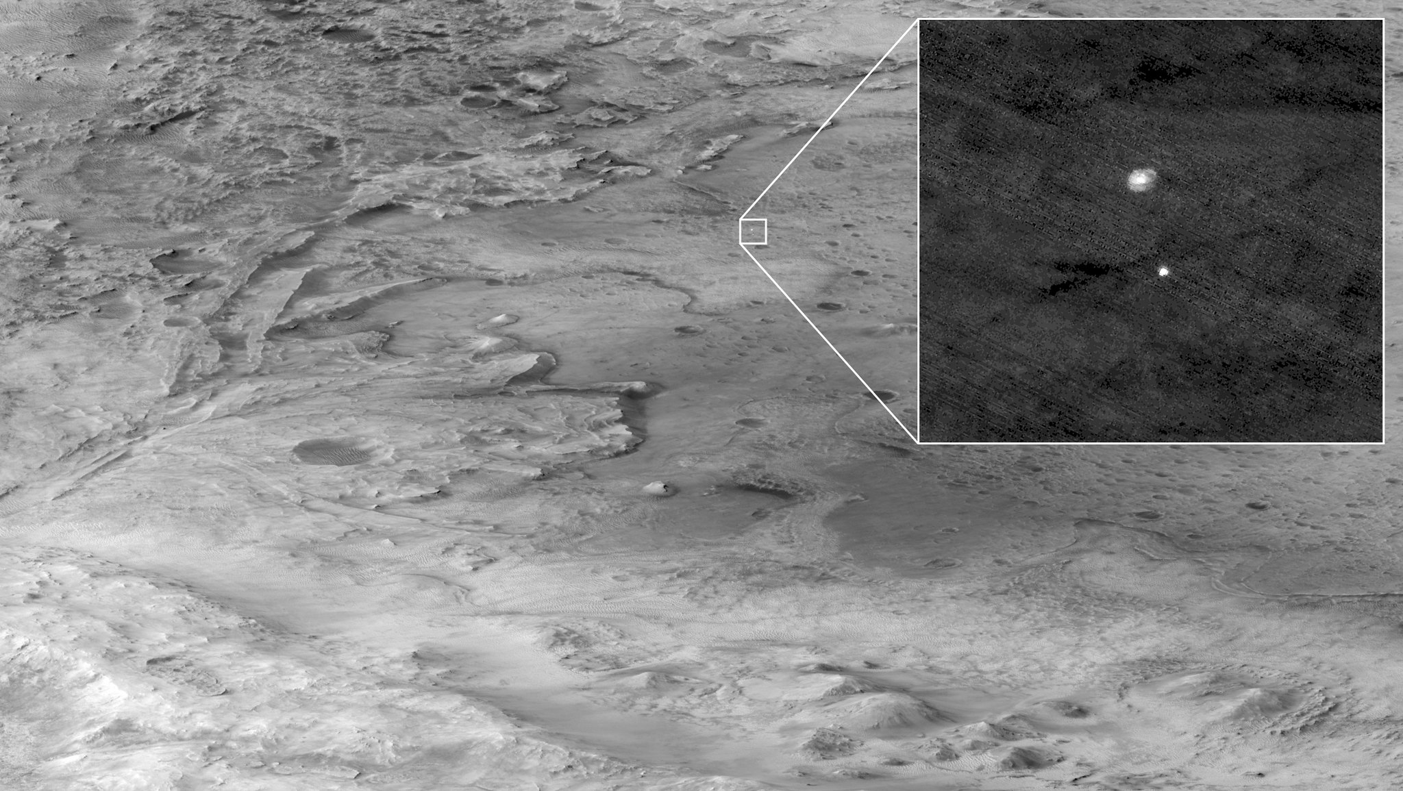 The Mars 2020 descent stage holding NASA’s Perseverance rover can be seen falling through the Martian atmosphere by the Mars Reconnaissance Orbiter’s HiRise camera, its parachute trailing behind, in this image taken on 18 February 2021. The ancient river delta, which is the target of the Perseverance mission, can be seen entering Jezero Crater from the left.
