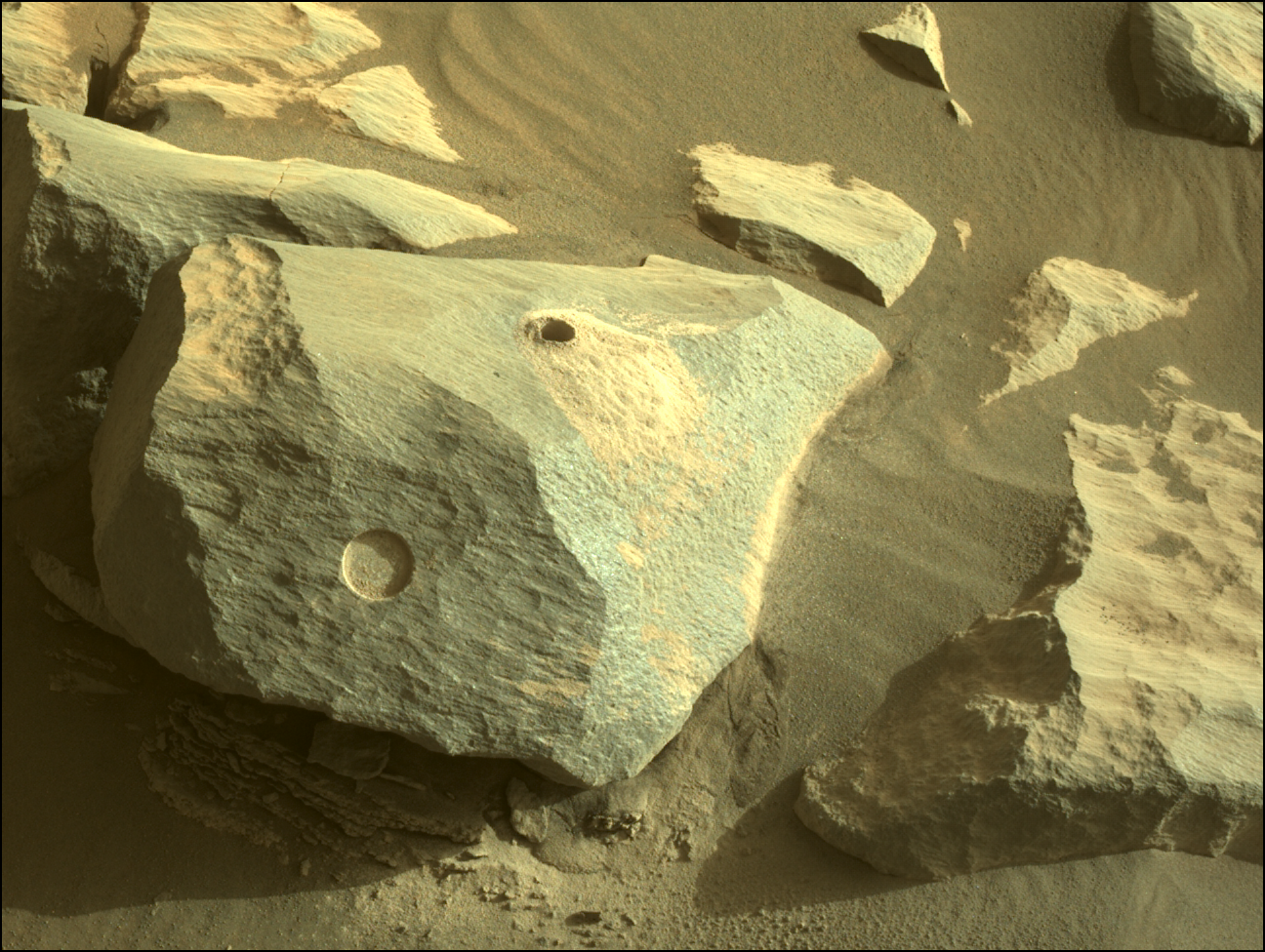 Image taken was taken by the Mars Perseverance rover after collecting the rock sample 8 at Ha'ahóni (aka "Hahonih"). This image shows the rock protruding out of the ground with an abrasion patch and a drill hole.