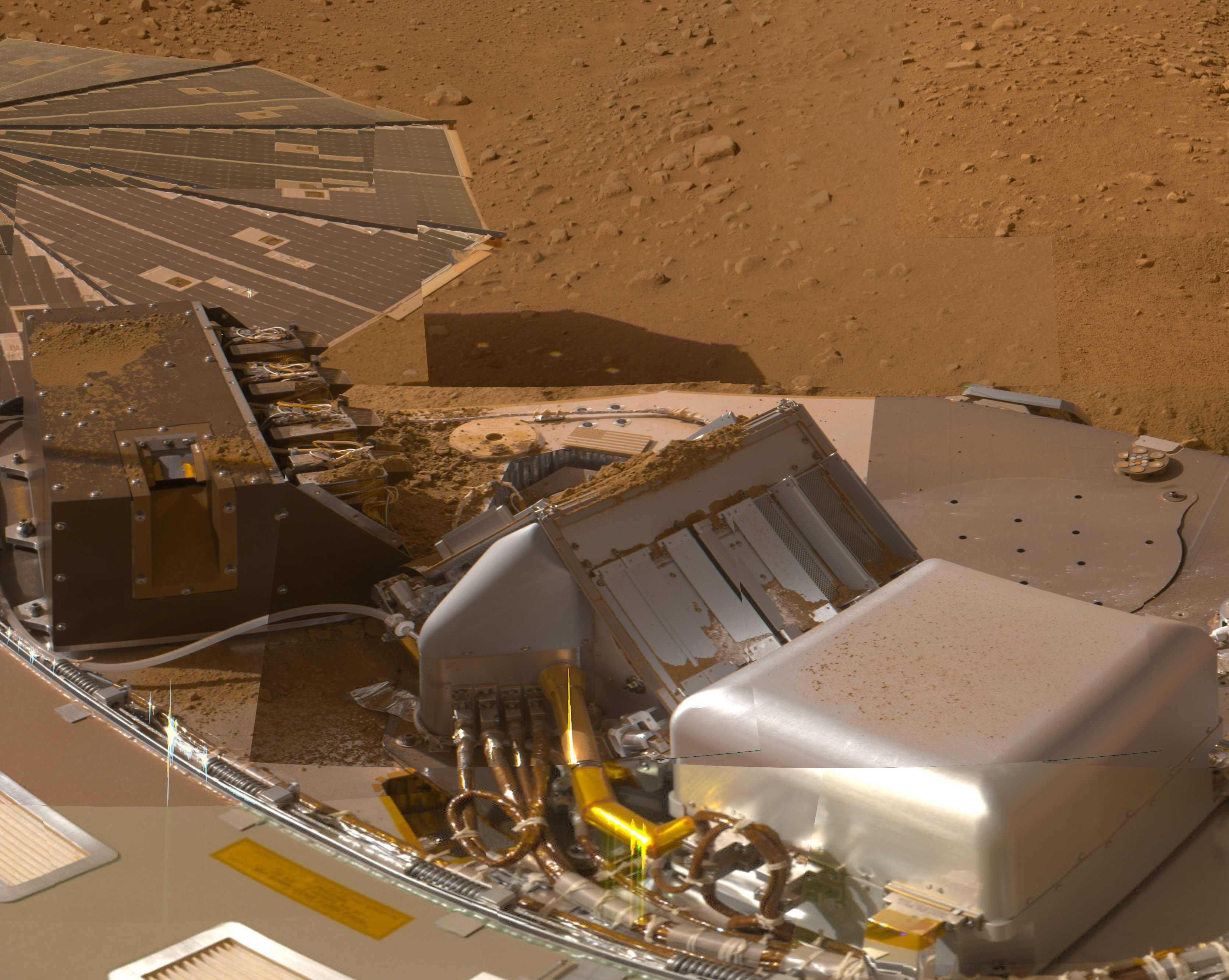 Dirt is scattered across the instrument deck of the lander.