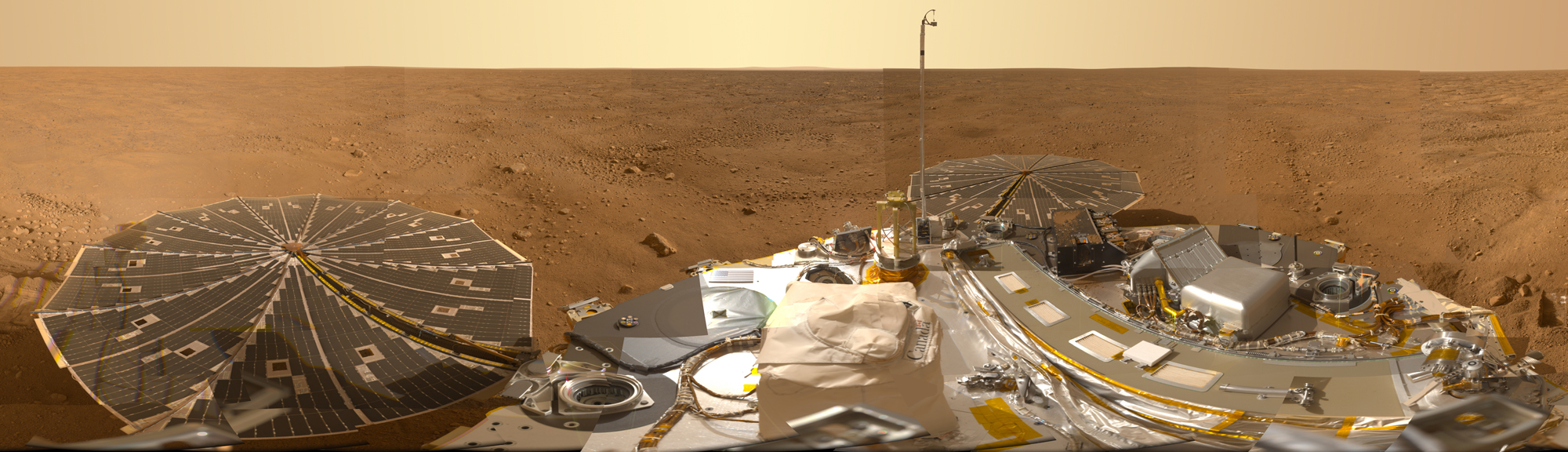 A wide, flat vista on the surface of Mars is visible above the instruments and solar panels of the lander.
