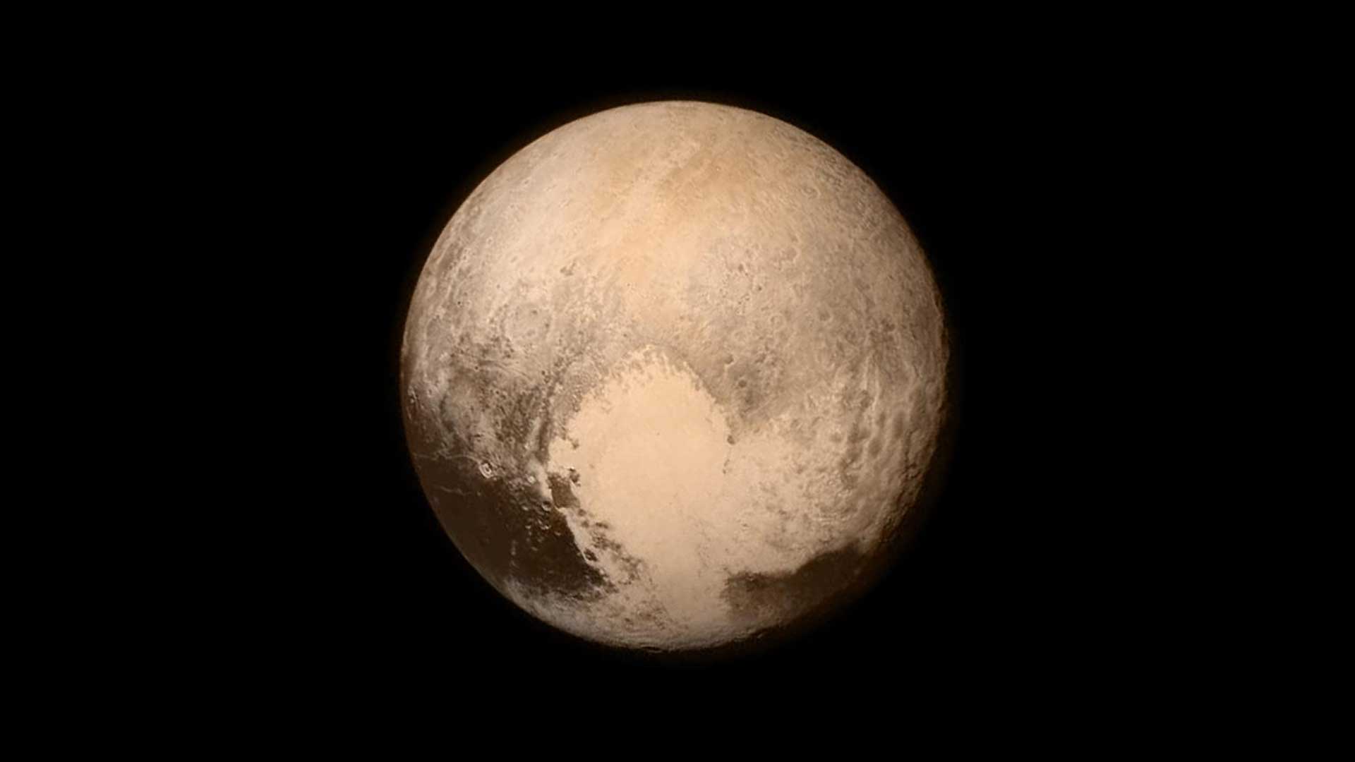 Pluto is reddish and has a heart shape lighter patch in the lower right half of this image from the New Horizons spacecraft.