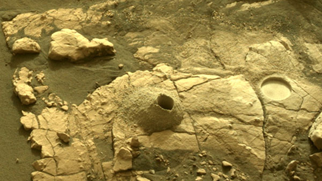 Image taken was taken by the Mars Perseverance rover after collecting the rock sample 12 at Hazeltop. There is a drill hole and a nearby abrasion patch displayed in this photo.
