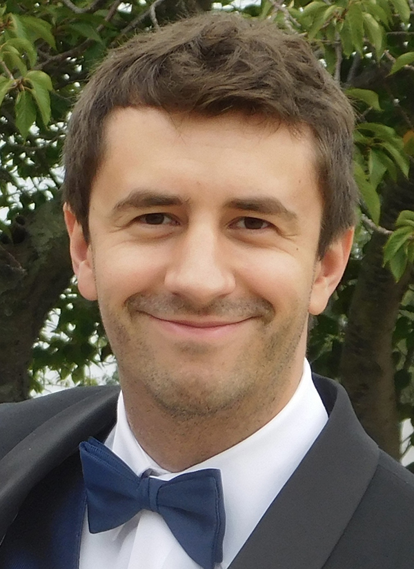 Paul Szypryt, male, brown hair, faint stubble beard, closed-mouth smile.