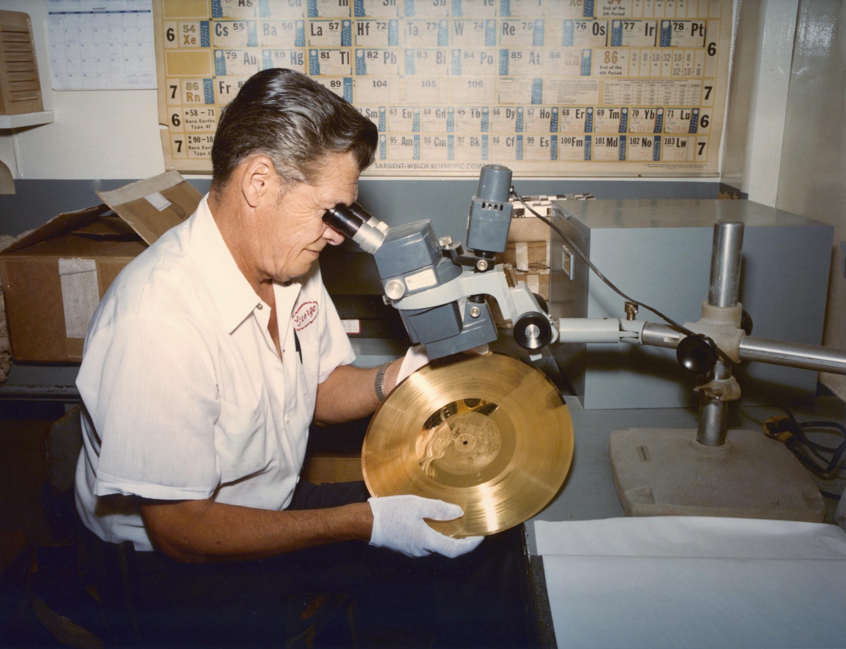 A man examines the Voyager Golden Record