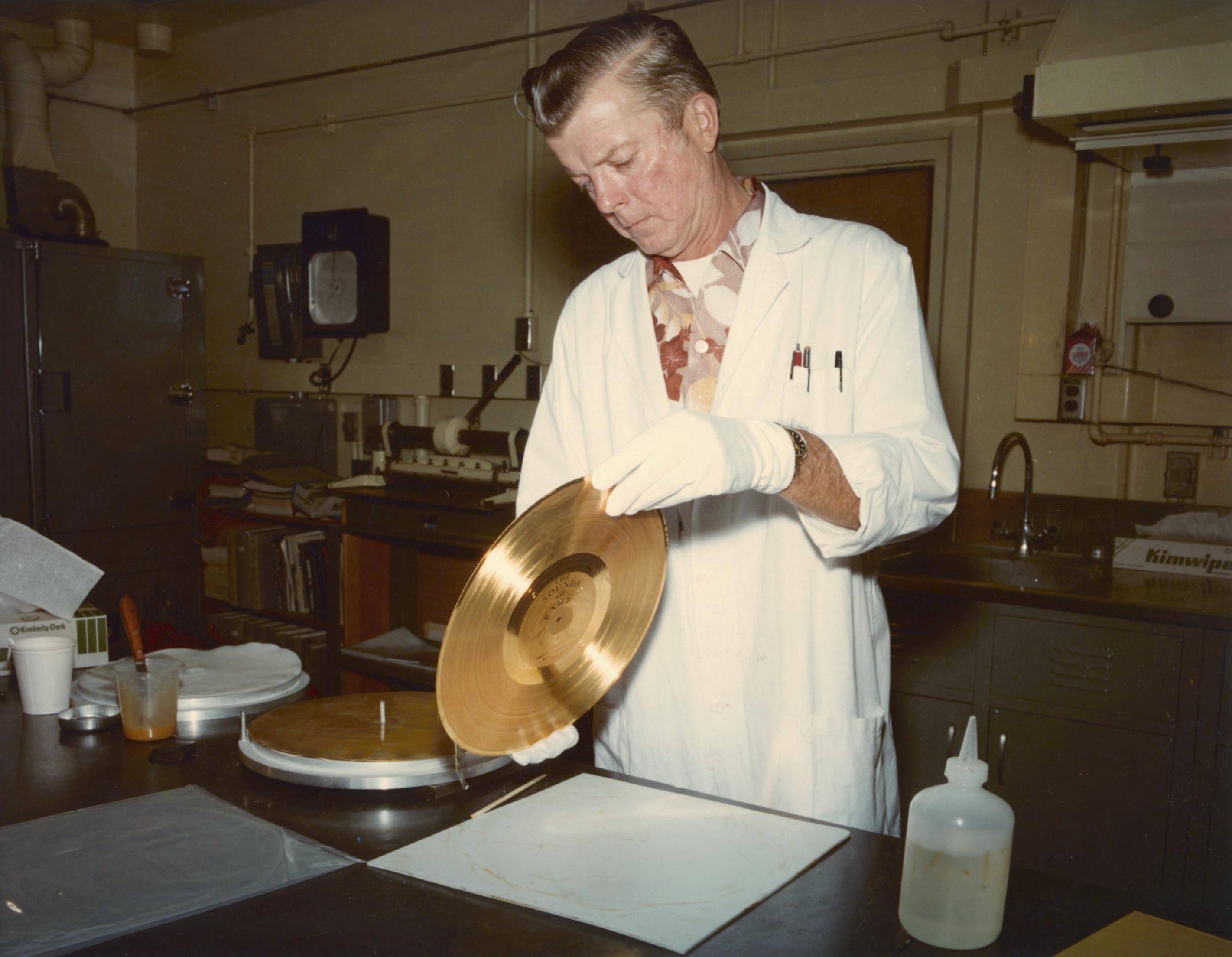 A man inspects the final Voyager Golden Record.