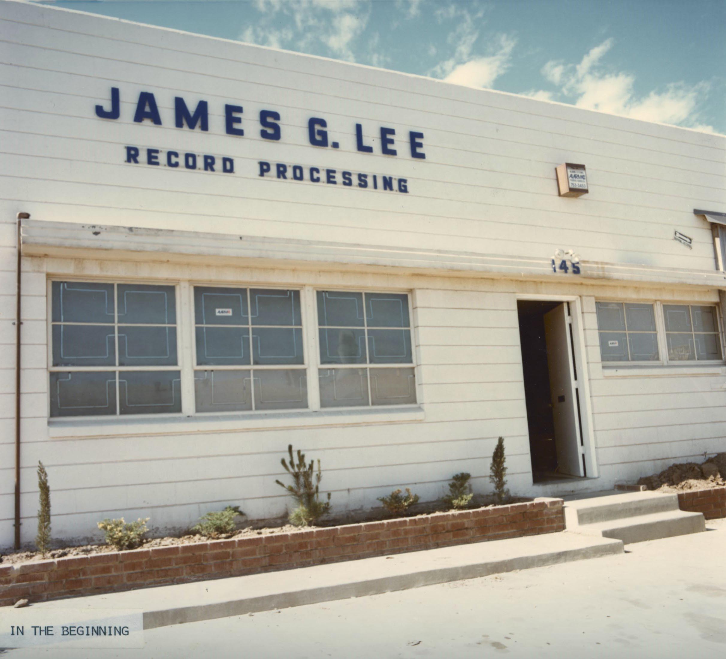 The James G. Lee recording studio is a white one story building.