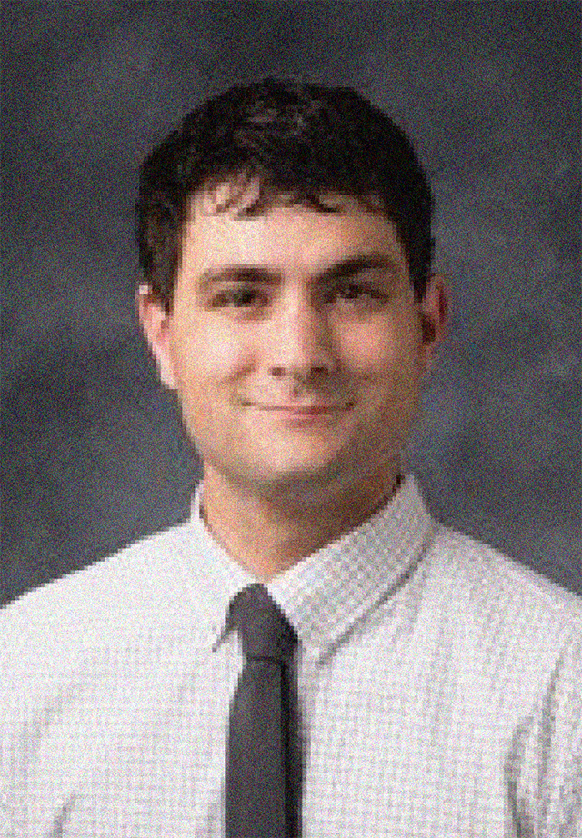Casey T. DeRoo portrait, male, dark brown hair, white button-down shirt, black tie, closed-mouth smile.