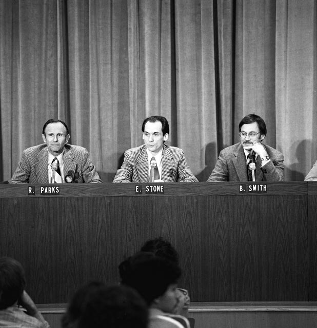 Ed Stone in the center of a panel of three speakers seated at a table