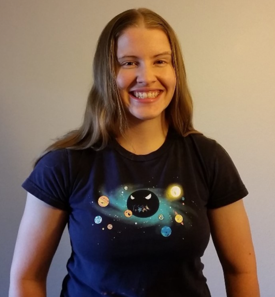 Portrait of Jamie S. Rankin, wearing a blue shirt with a solar system design on it