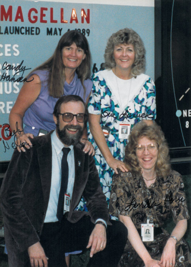 Four JPL employees, including Linda Spilker, posing for a photo