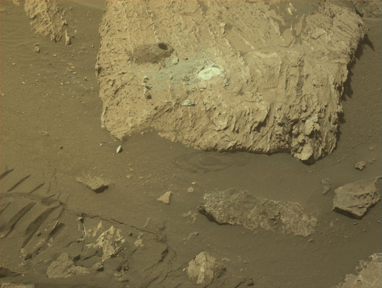 Image of a rock on Mars with a hole and patch next to each other of Mars Rock Sample 25.