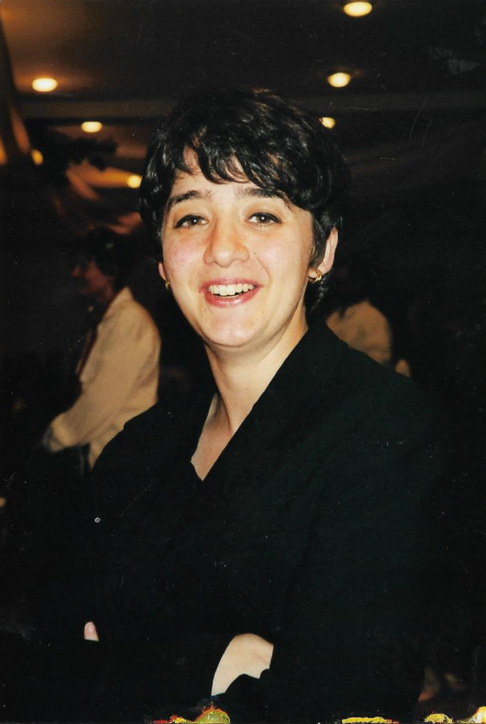 Portrait of Merav Opher, facing the camera and smiling