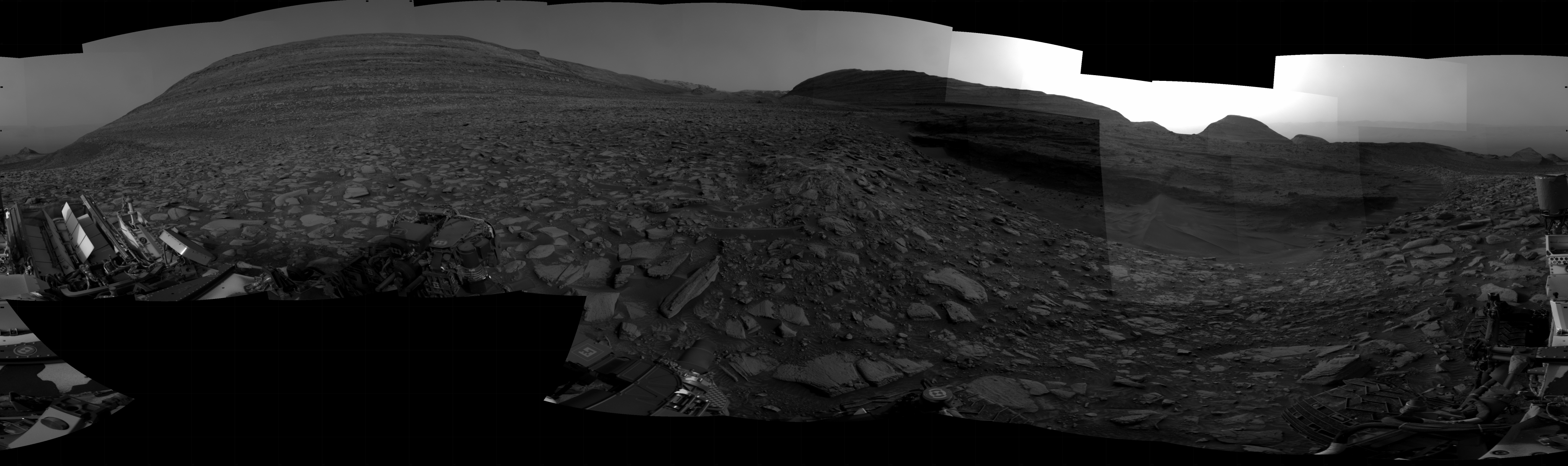 NASA's Mars rover Curiosity took 31 images in Gale Crater using its mast-mounted Right Navigation Camera (Navcam) to create this mosaic. The seam-corrected mosaic provides a 360-degree cylindrical projection panorama of the Martian surface centered at 166 degrees azimuth (measured clockwise from north). Curiosity took the images on March 22, 2024, Sol 4132 of the Mars Science Laboratory mission at drive 954, site number 106. The local mean solar time for the image exposures was from 3 PM to 4 PM. Each Navcam image has a 45 degree field of view.