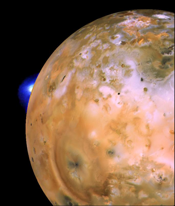 A giant plume erupts from the limb of Io, which is mottled with volcanoes.