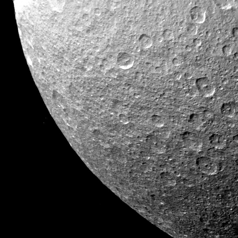 A closeup of the limb of Rhea reveals a surface covered with impact craters.