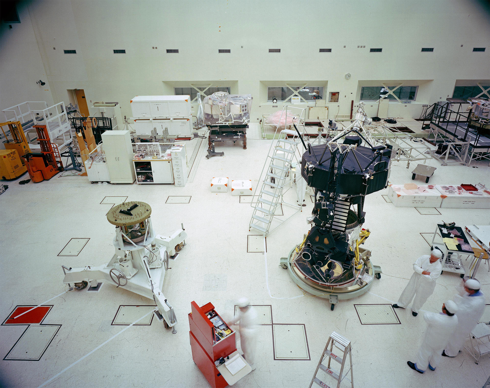 Voyager Proof Test Model (in the foreground right of center) undergoing a mechanical preparation and weight center of gravity test