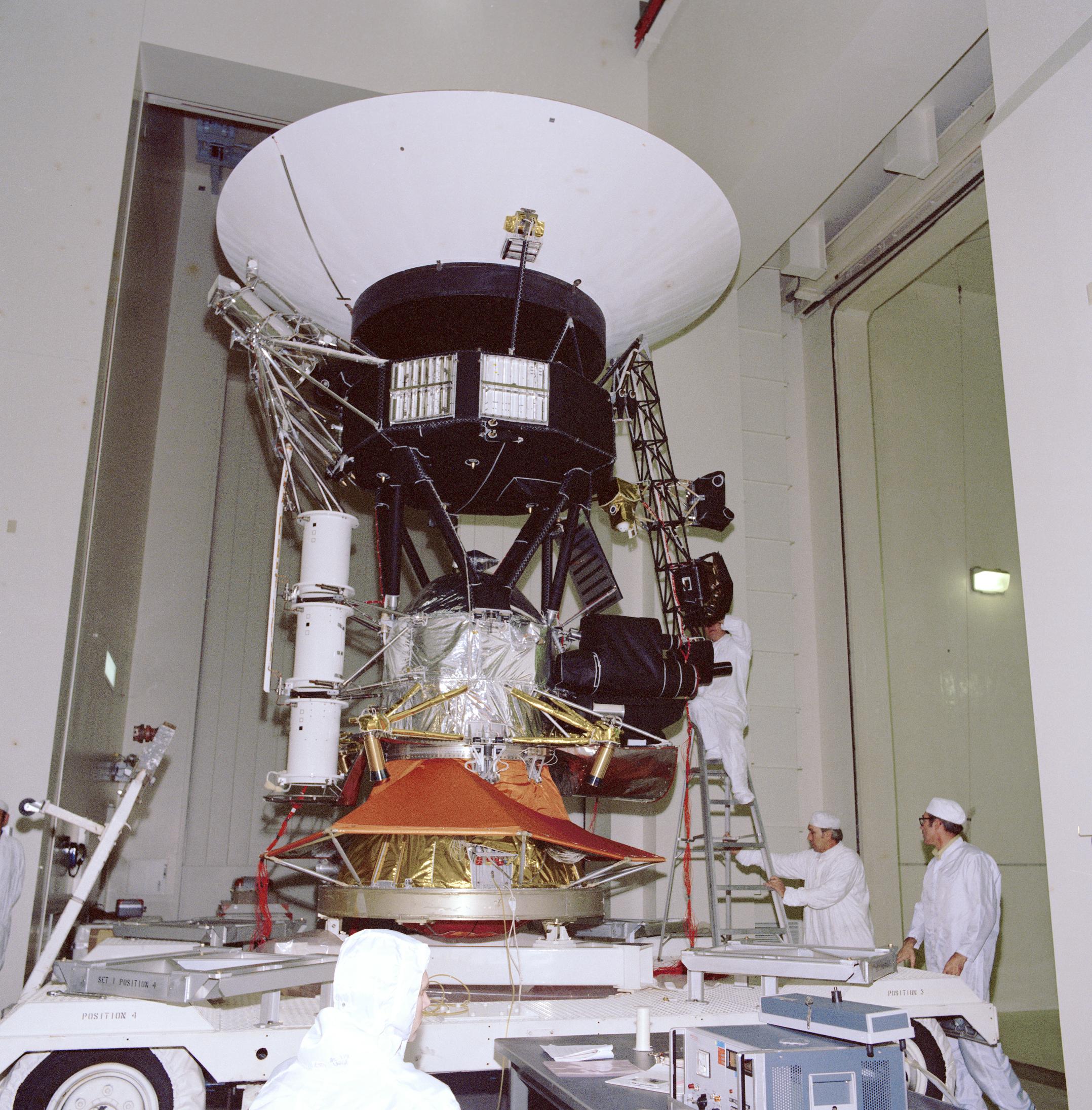Engineers working on vibration acoustics and pyro shock testing of NASA's Voyager