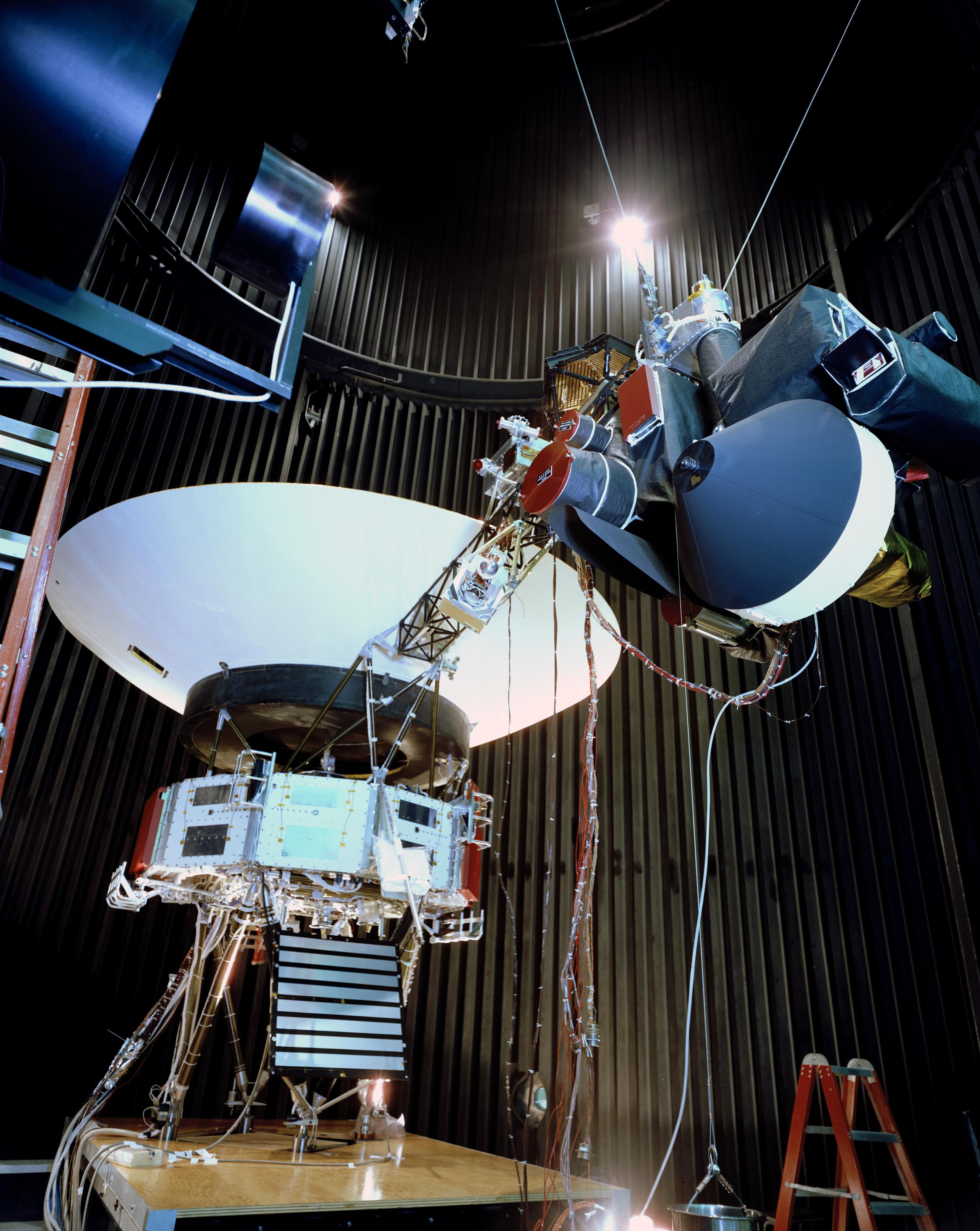 Voyager proof test model in the 25-foot space simulator chamber at NASA's Jet Propulsion Laboratory. The spacecraft is seen here with its scan platform, which holds several of its science instruments, in the deployed position.