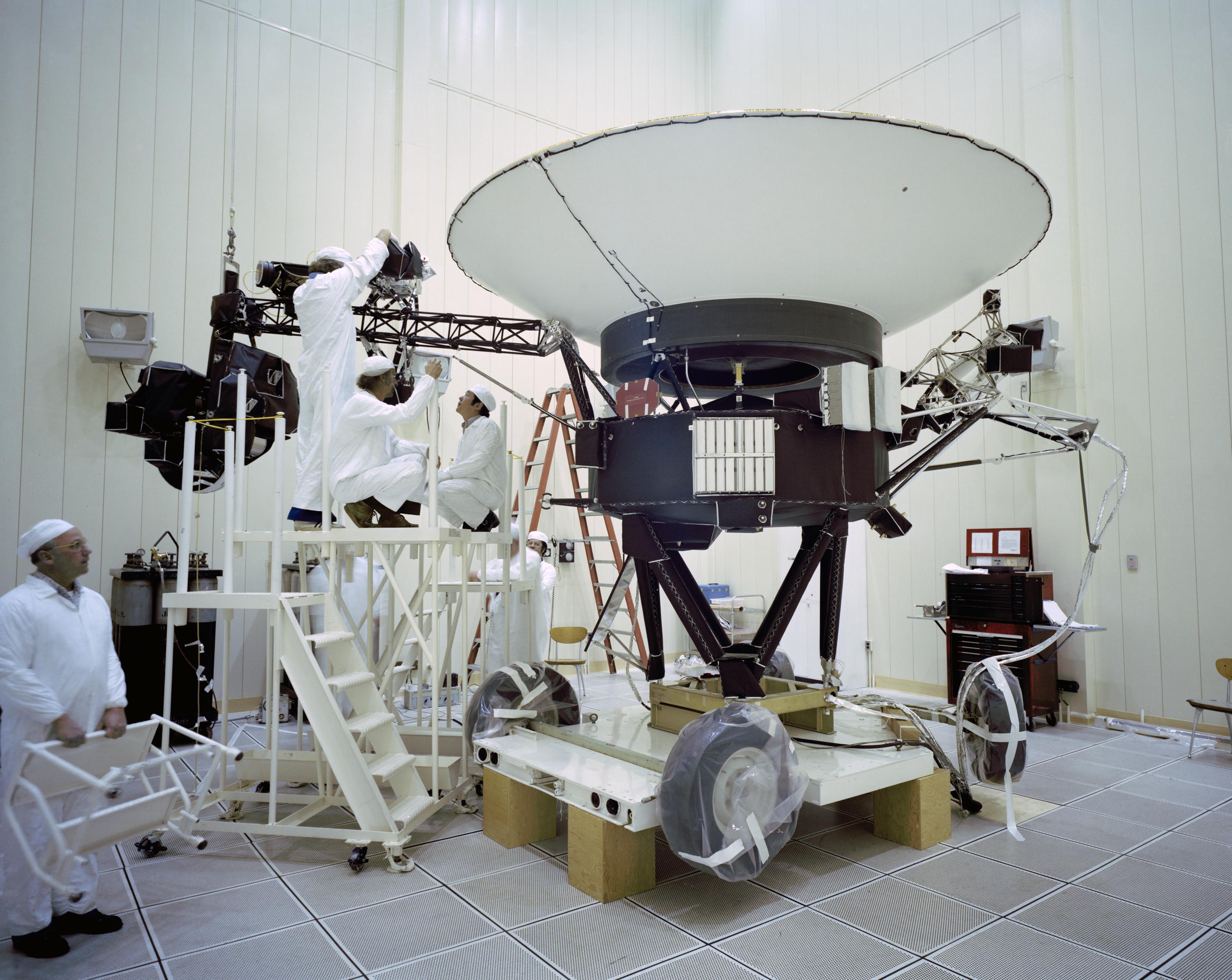 Engineers working on NASA's Voyager 2 spacecraft inside a lab