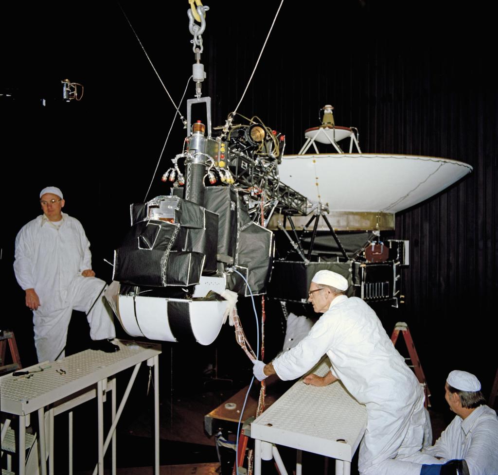 One of the Voyagers in the 25-foot space simulator chamber with engineers at NASA's Jet Propulsion Laboratory