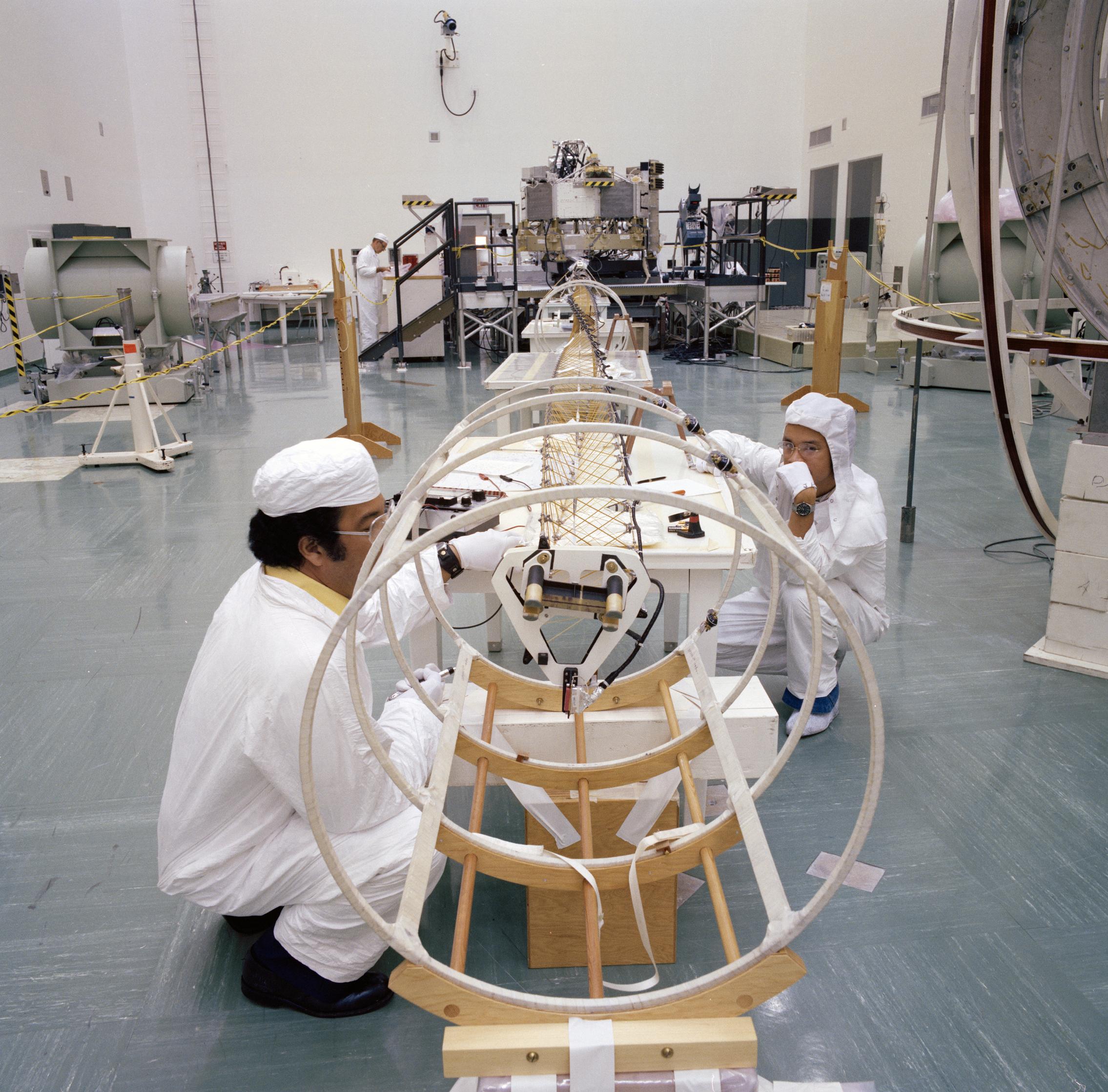 Engineers working with the deployed magnetometer boom of one of NASA's Voyager spacecraft