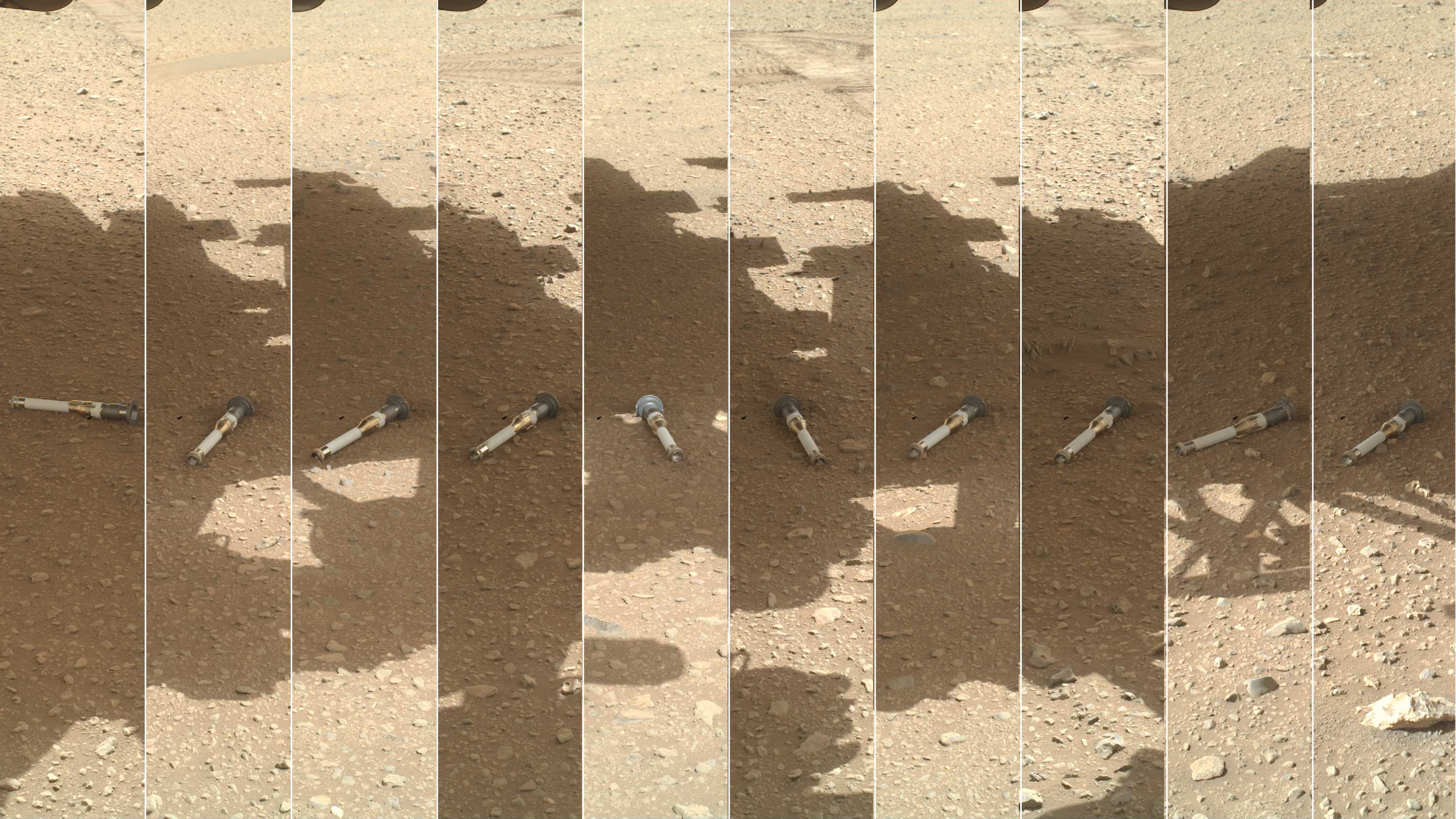 Nine small tubes lay in the shadow of the rover on the surface of Mars.