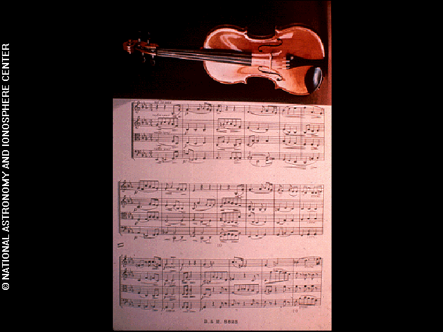 The violin with music score (Cavatina) image is one of the pictures electronically placed on the phonograph records which are carried onboard the Voyager 1 and 2 spacecraft.