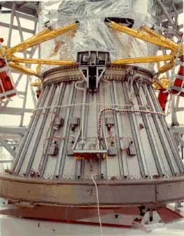 A large cylindrical structure used to mount a spacecraft to the top of a rocket.