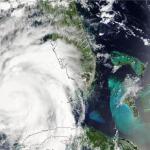 Hurricane Idalia as photographed by NASA's Terra satellite in August 2023. The swirling mass of the hurricane passes over some land masses and the ocean.