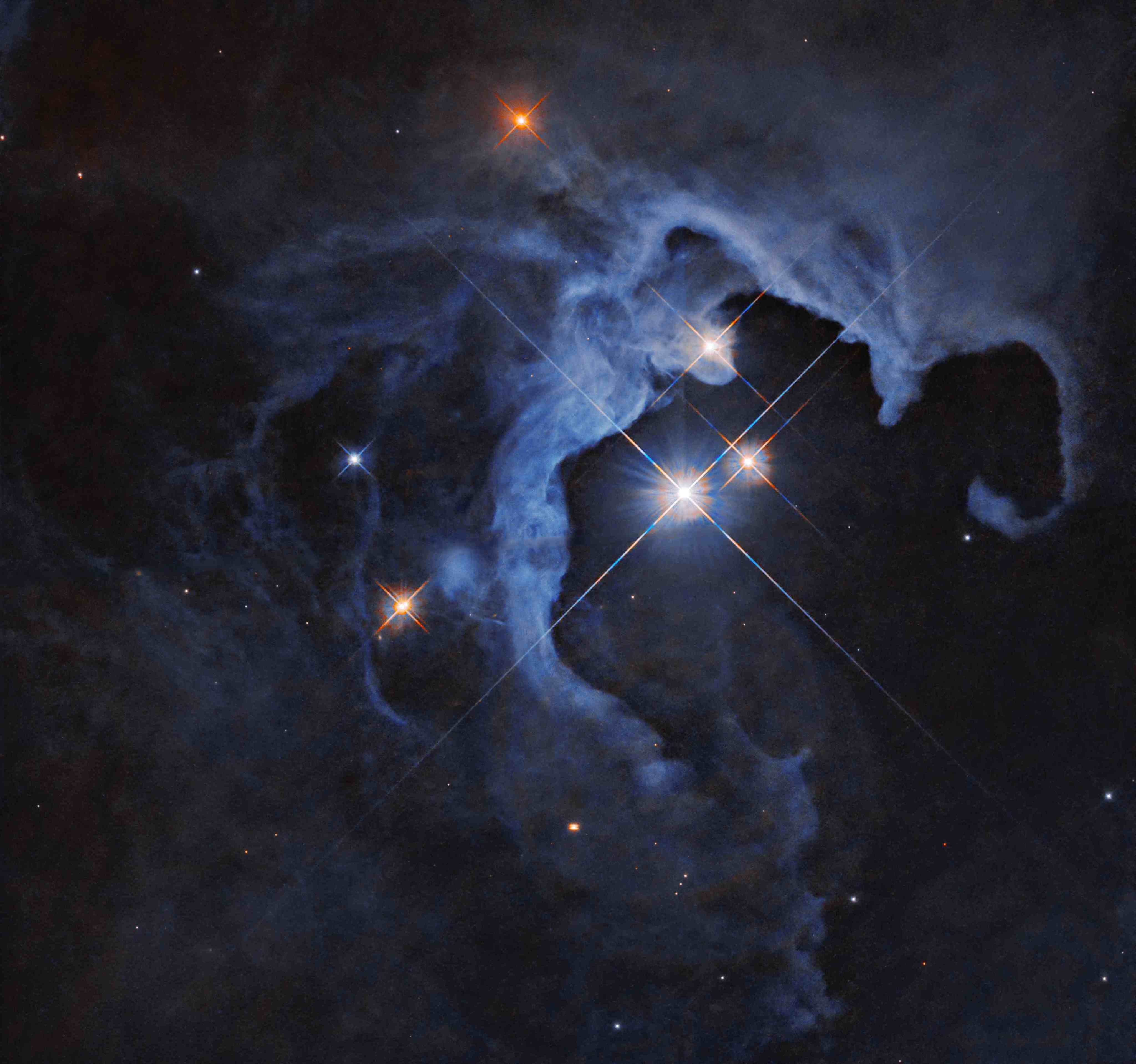 Three bright stars with diffraction spikes shine near the center-right of the image, illuminating nearby clouds that glow in pale blue. The clouds darken at the edges of the image, and are dotted with smaller stars, some also with diffraction spikes.
