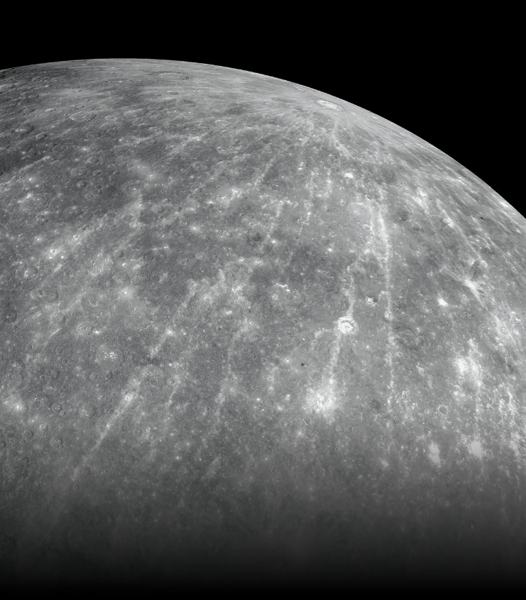 Close up view of the limb of Mercury showing a battered, cratered surface.