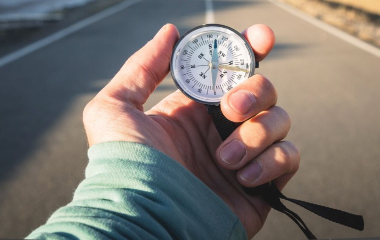 A hand is outstretched holding a stop watch.