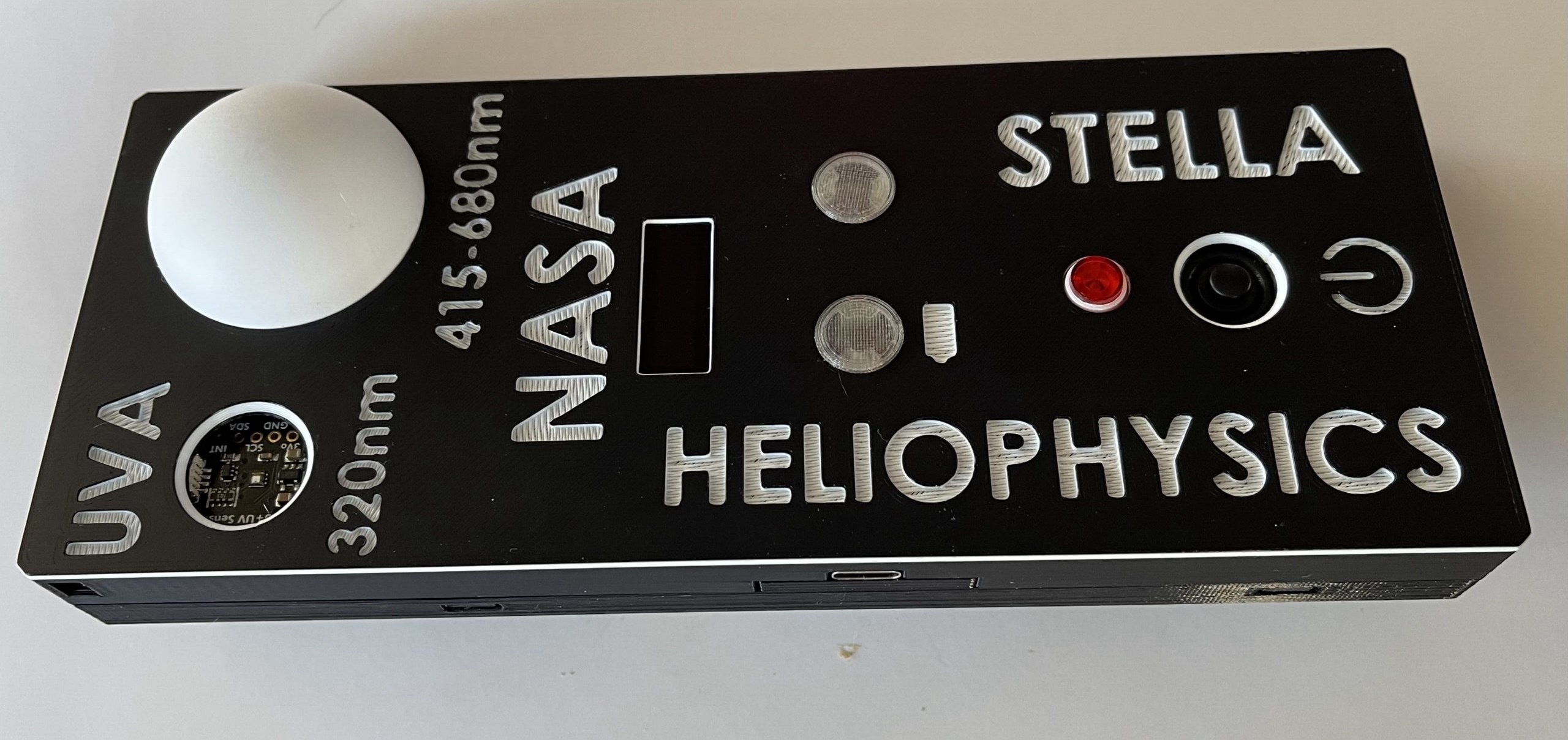 black box remote sensing device with 'STELLA' and 'HELIOPHYSICS' and 'NASA' spelled