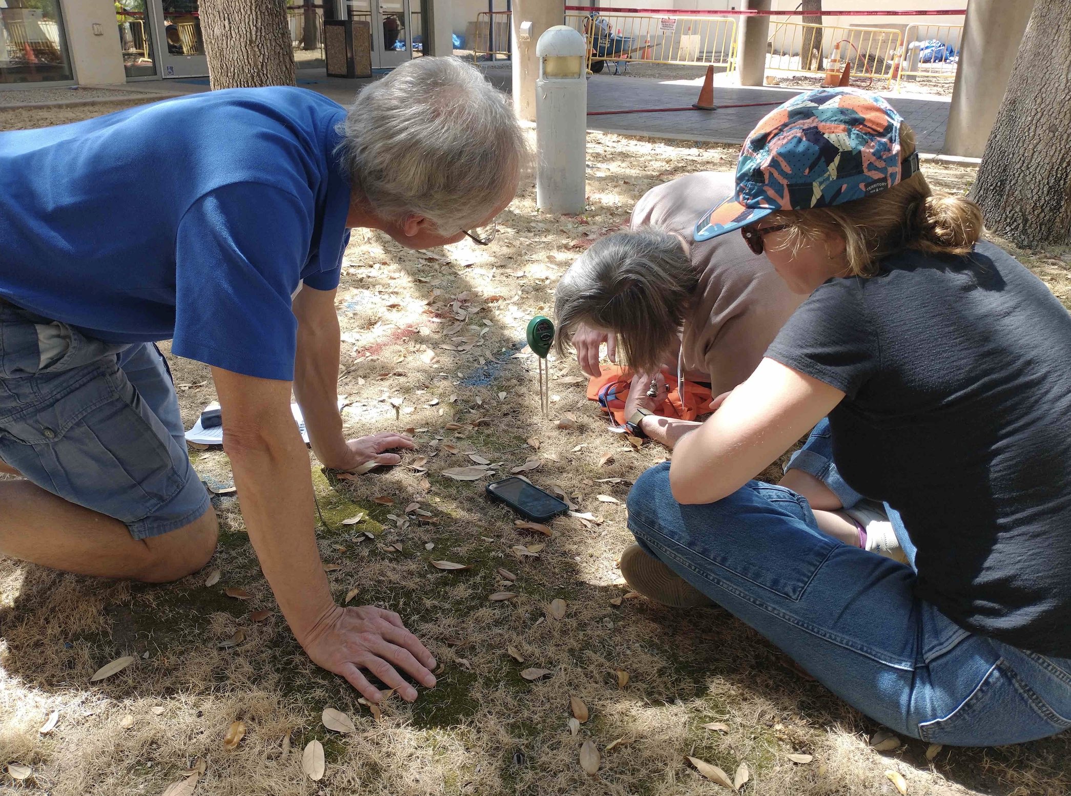 PLACES project team members (left, Kevin Czajkowski; middle, Tracy Ostrom; right, Eliza Jacobs) collect data using a soil moisture probe as part of the 2023 Summer Institute in Tucson, AZ.