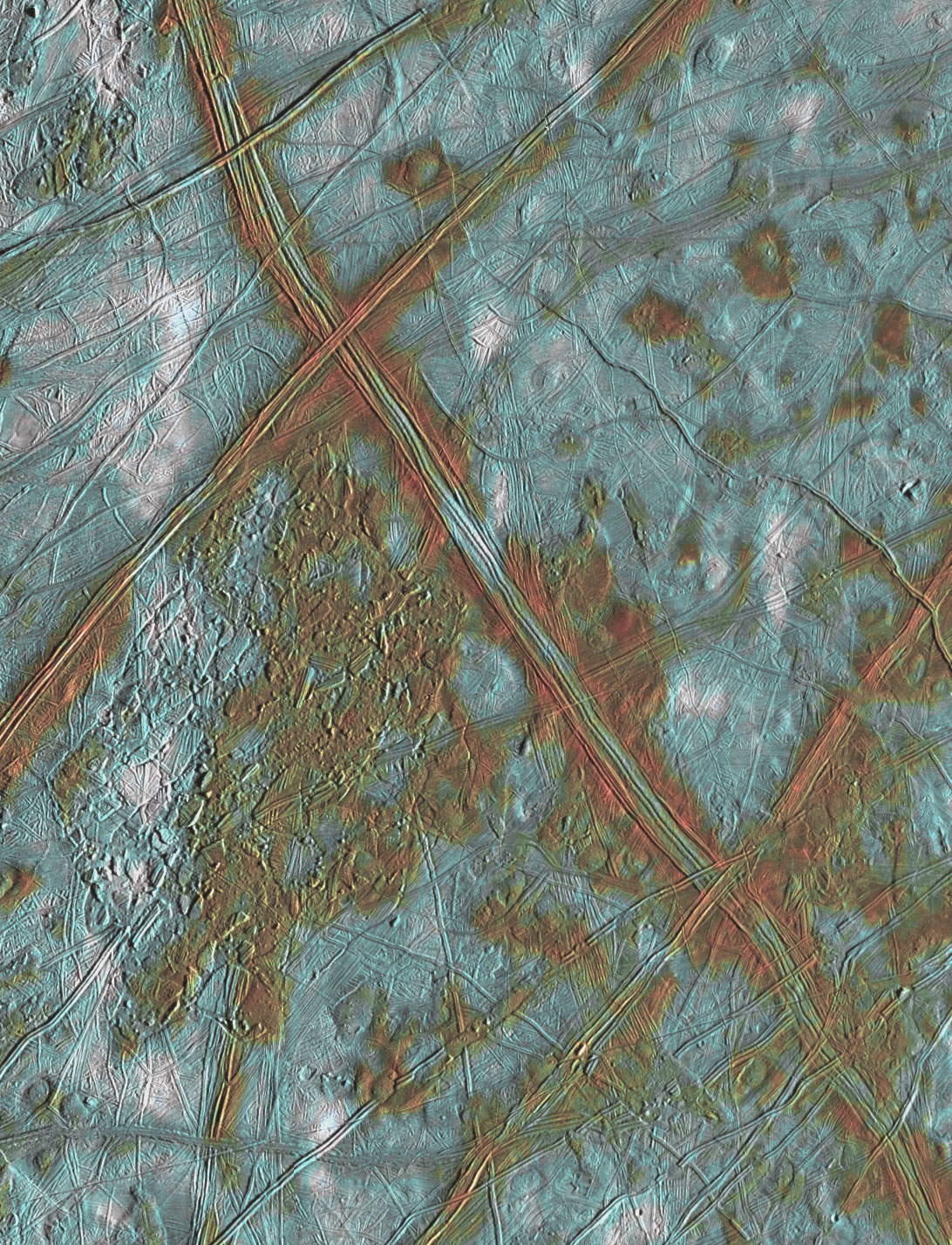 This close up image of Europa's surfaces has color added so it appears reddish and blue with white patches.