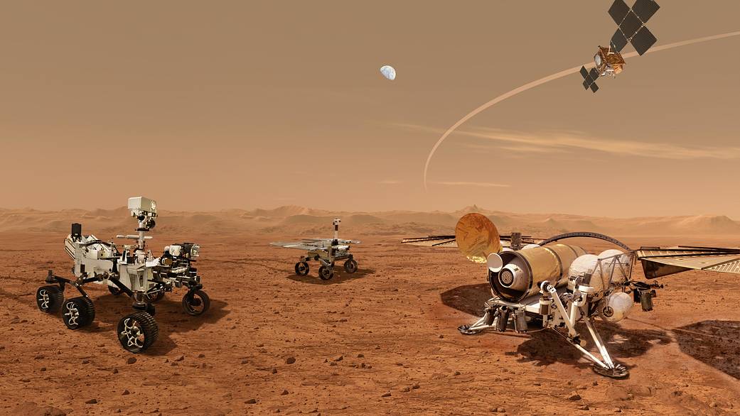 This is an artist's concept depicting a future NASA Mars mission, featuring multiple rovers and landers on the Martian surface. The scene includes detailed robotic rovers exploring the red planet's terrain, a lander with extended solar panels, and an orbiting spacecraft above, illustrating a coordinated effort to study Mars. The Martian landscape is characterized by its reddish hue, rocky ground, and distant mountainous horizon, with Earth visible in the background sky.