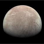 Europa has reddish brown lines and patches in this image from Juno.